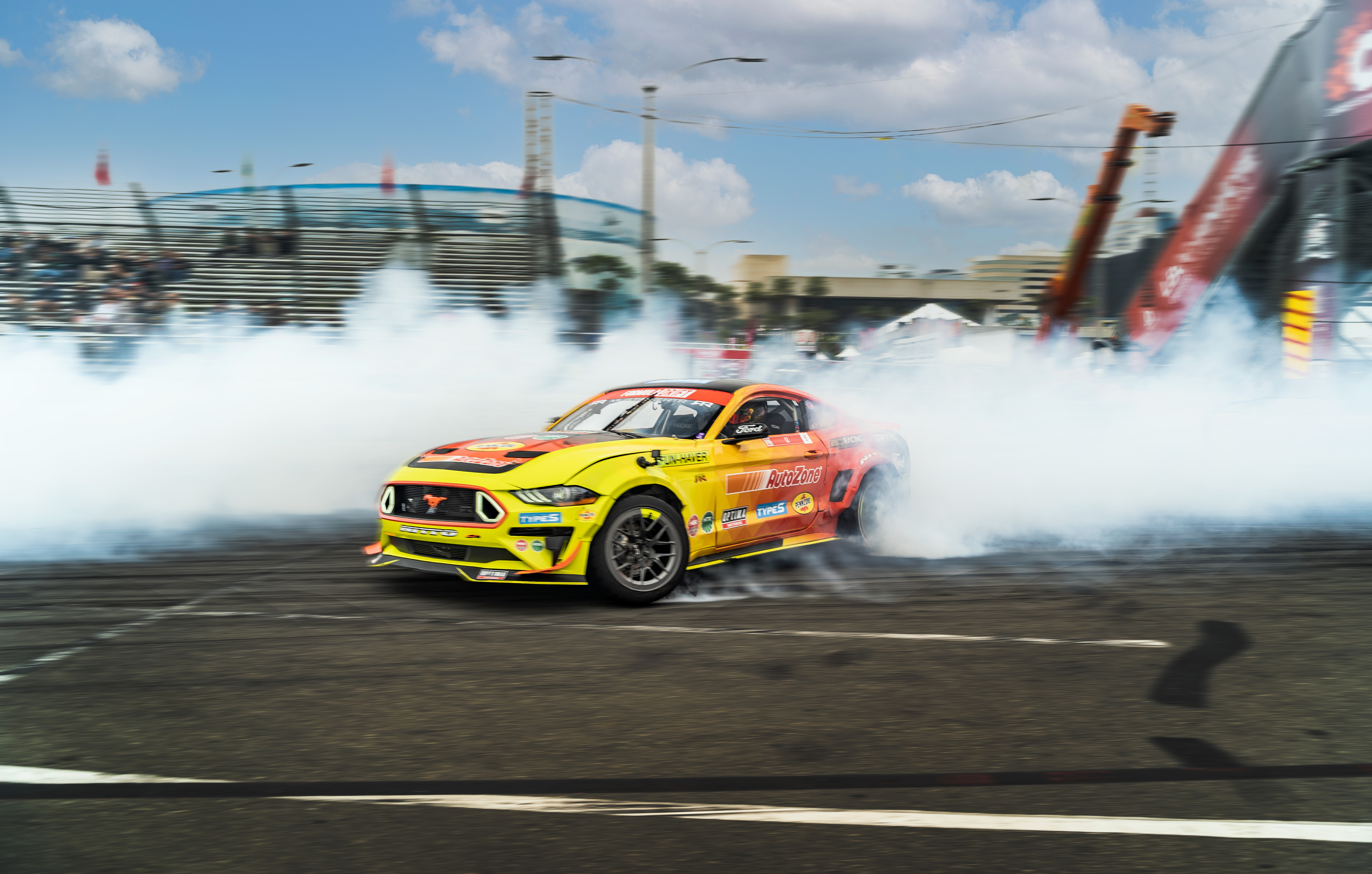 Drift car creating smoke on a city circuit